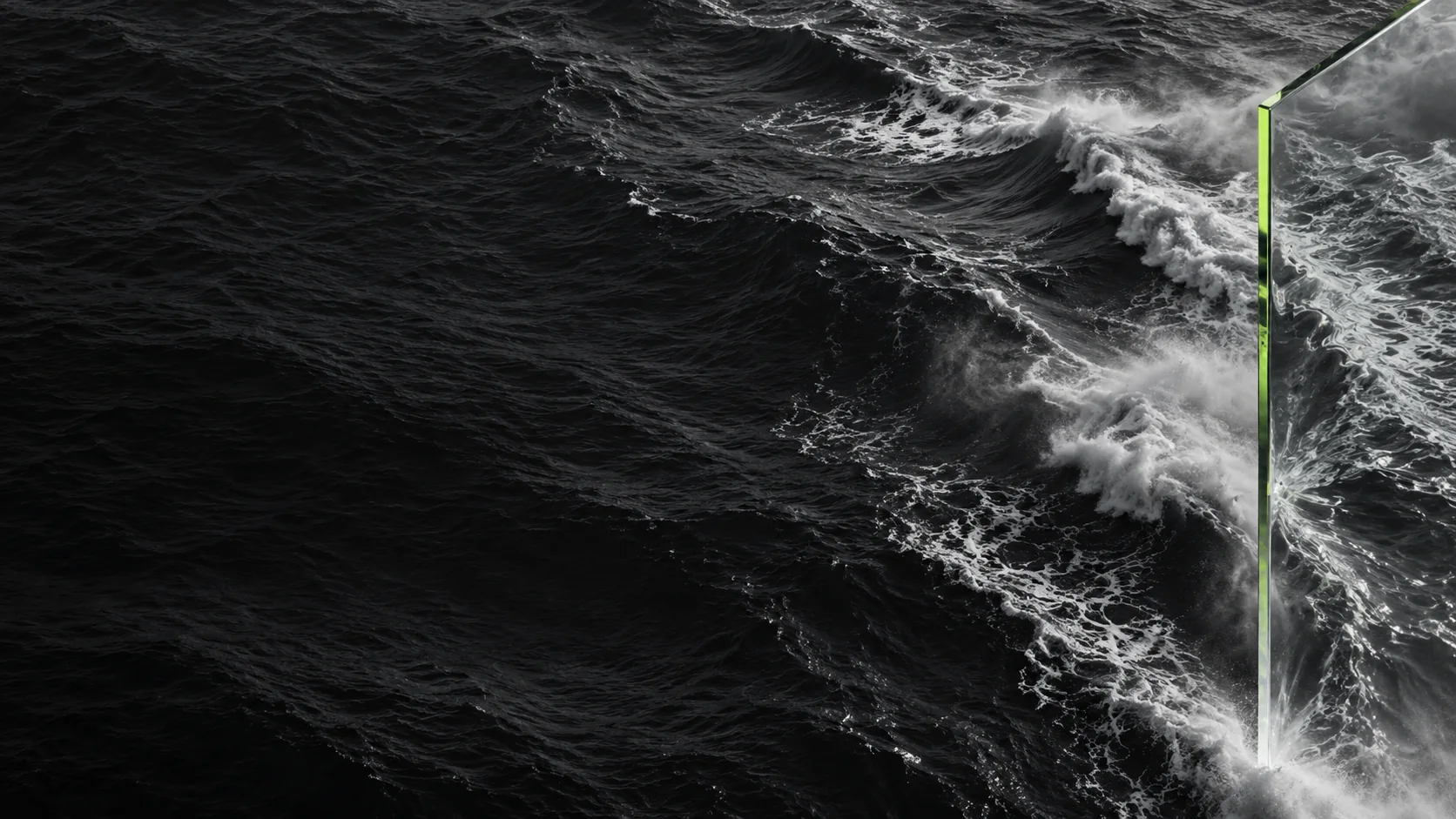 Silver ocean waves seen through a clear glass edge